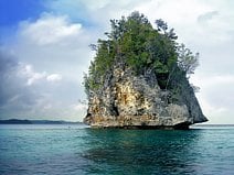photo d’un rocher qui émerge devant l’île paradisiaque de Kadidiri